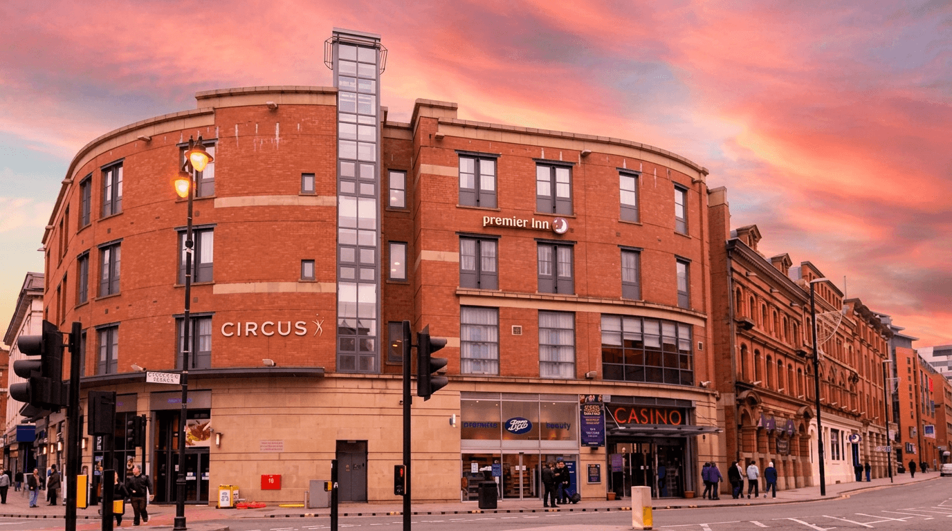 Exterior of Premier Inn Manchester City Centre on Portland Street at sunset